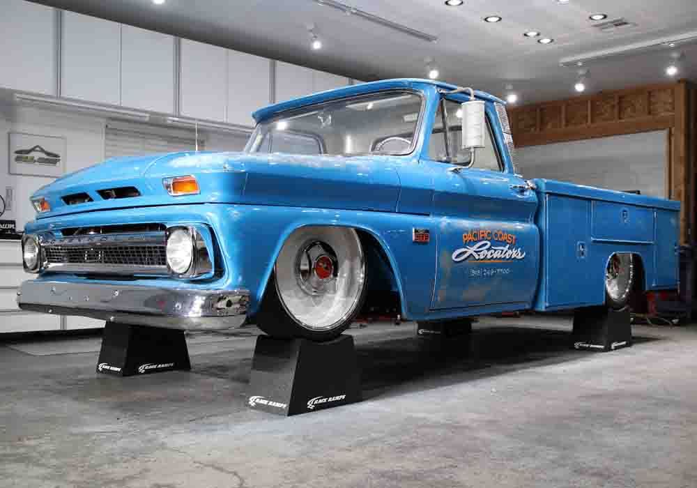 Blue Pacific Coast Locators truck up on Race Ramps Wheel Cribs in a garage