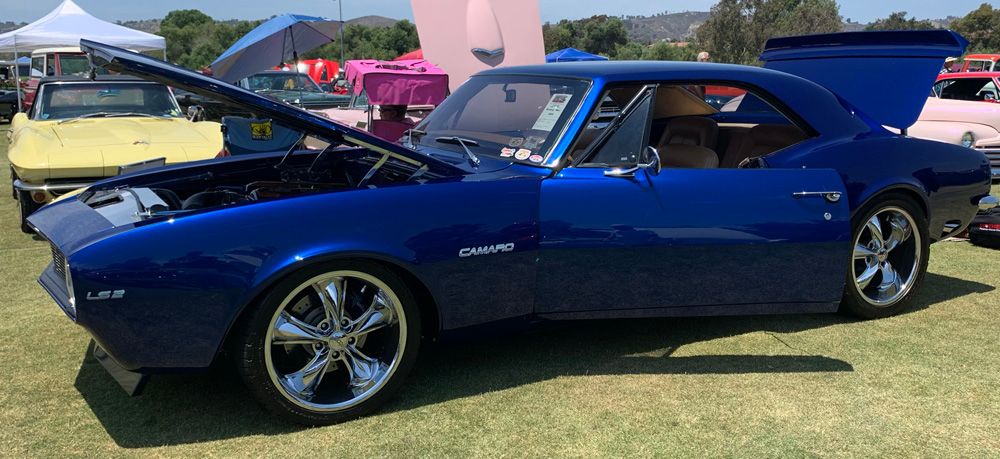 Chevy Camaro LS2 Series with windows down, hood up and trunk open at a classic car show