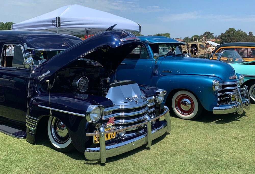 Classic cars with hood open at a classic auto show